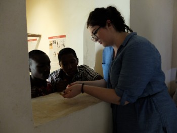 Members of the CONCH team pictured handling and looking at the objects from the two display cases. (Photo: Sara Perry).