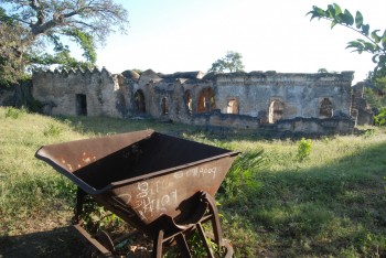 Kilwa Great mosque in the background and one of the trucks from the original archaeological campaign in the front.