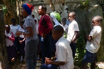 Figure 3: UDSM student Betina Mapunda, explaining to primary student about the history and importance of Fort Kikokwe. Photo credit Elinaza Mjema.