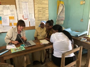 Patricia looking at Activity Sheets with teachers from Pangani Primary School